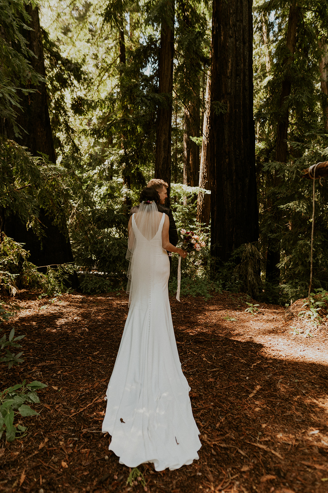 First look between bride and groom in the Redwoods of California in Big Sur