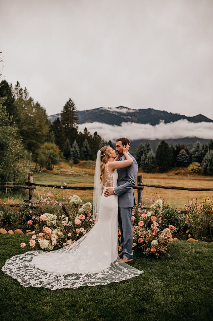Happy bride and groom kiss at the altar after saying I Do at the Sixty Chapel in Garden Valley Idaho