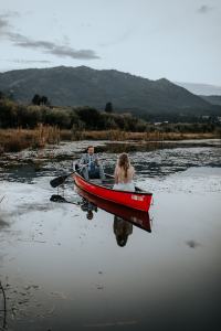 Bride and groom take a canoe ride on their wedding day at the Sixty Chapel Wedding Venue in Idaho