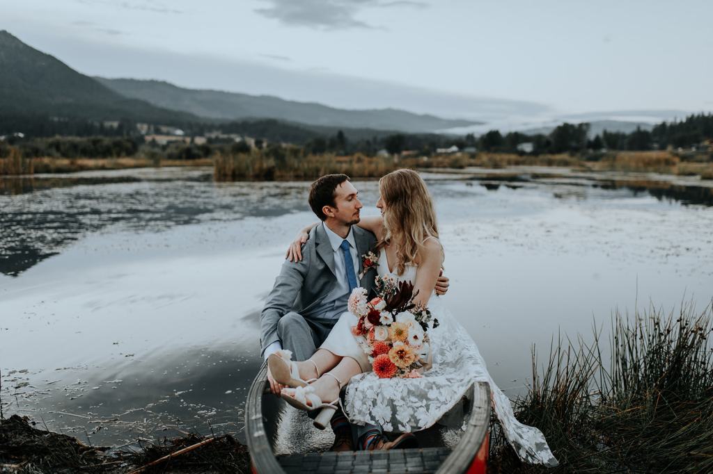 Bride and groom take a canoe ride on their wedding day at the Sixty Chapel Wedding Venue in Idaho