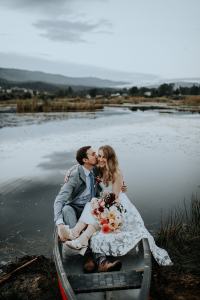 Bride and groom take a canoe ride on their wedding day at the Sixty Chapel Wedding Venue in Idaho