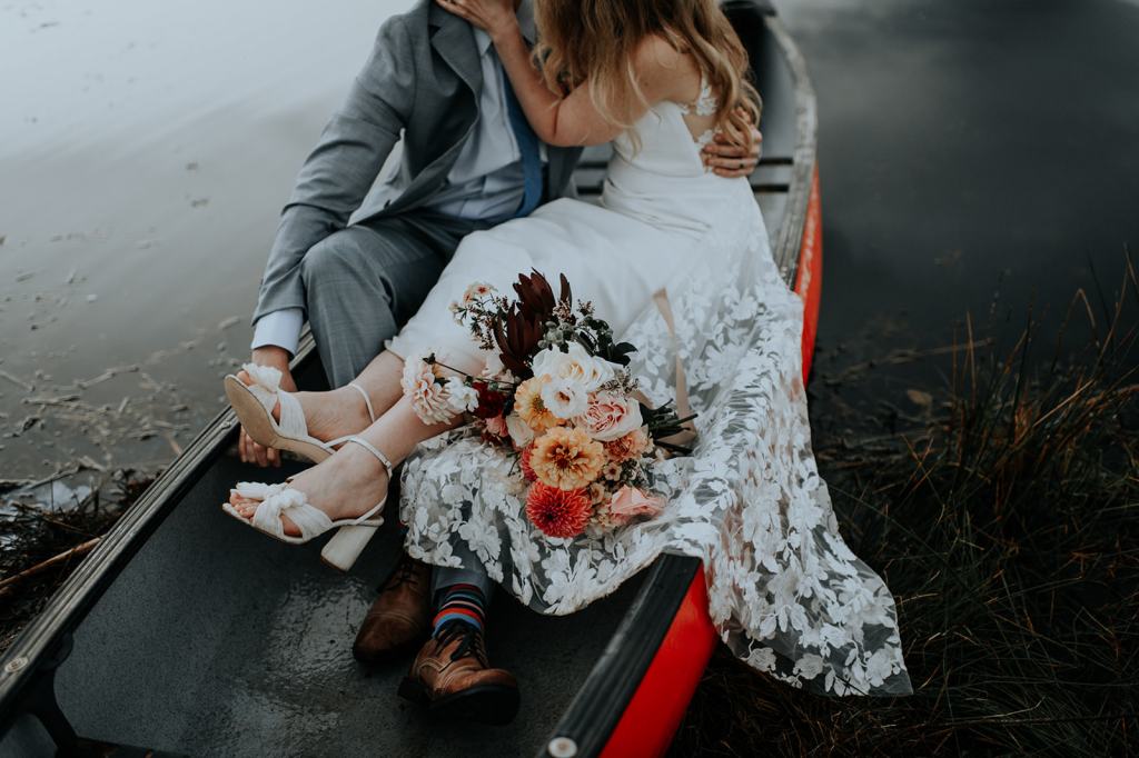Bride and groom take a canoe ride on their wedding day at the Sixty Chapel Wedding Venue in Idaho