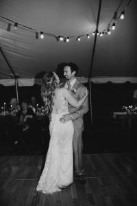 Bride and Groom share their first dance on their wedding day under reception tent at the Sixty Chapel in Garden Valley Idaho