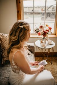 bride puts on her earrings and gets ready for her wedding day at the Sixty Chapel in Garden Valley Idaho