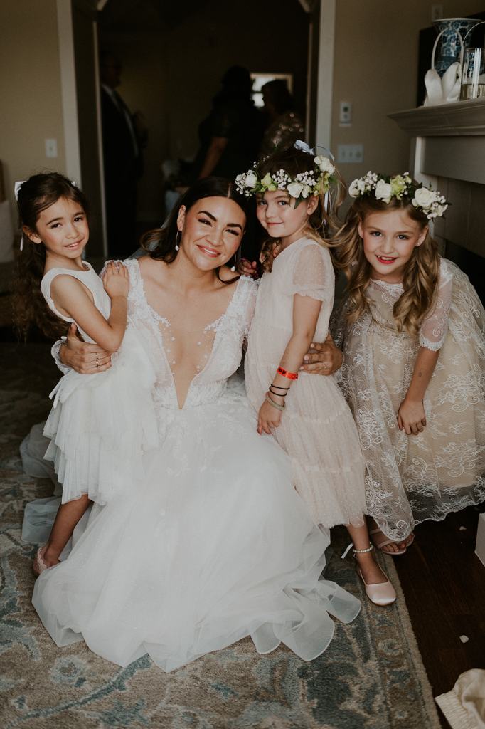 Candid Portrait of bride and her flower girls on wedding day 