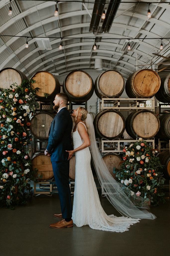 Bride grabs the grooms butt during their funny first look at a winery