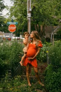 Backyard Lifestyle Maternity session on a summer day in Boise Idaho with a toddler and dog in the garden